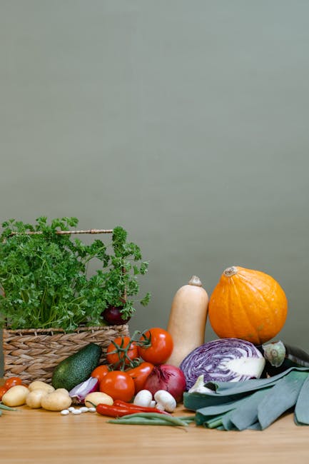 A vibrant variety of organic vegetables arranged on a wooden table with a woven basket.